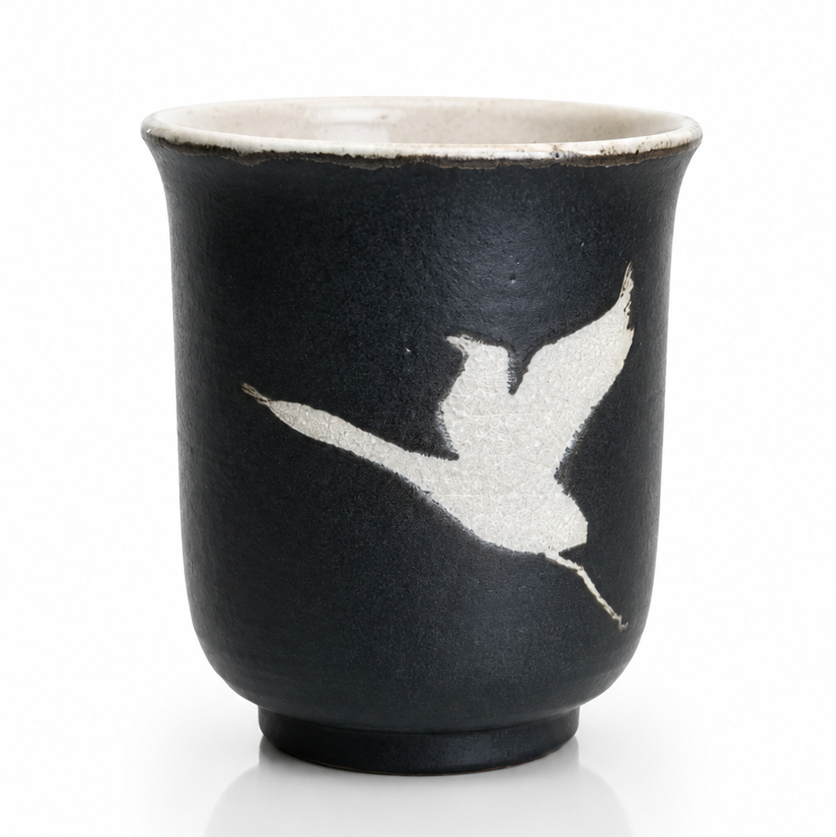Black Japanese yunomi tea cup with traditional crane design handcrafted in Ibaraki, Japan.