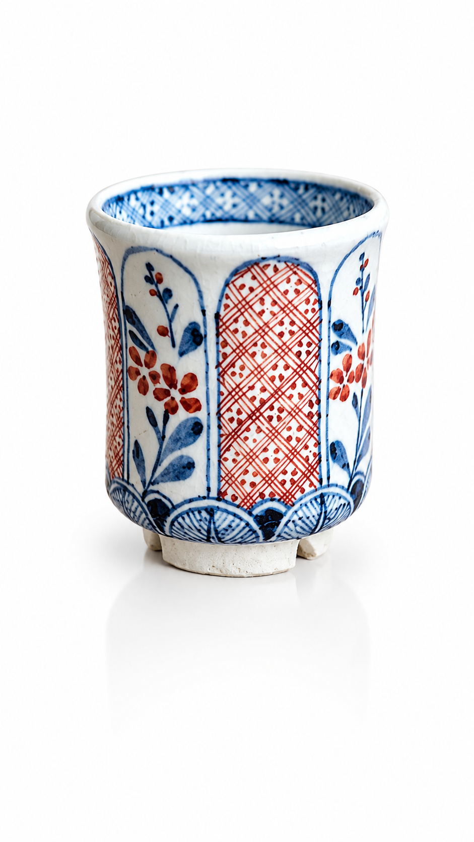 Traditional Japanese ceramic tea cup with red and blue motifs
