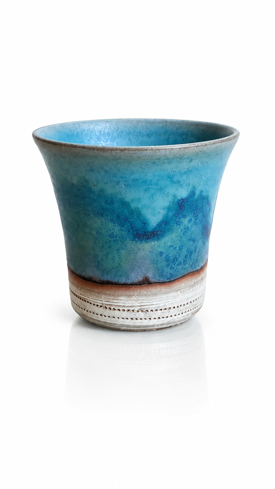 Handmade Japanese yunomi tea cup with blue Yohen glaze inspired by ocean waters.