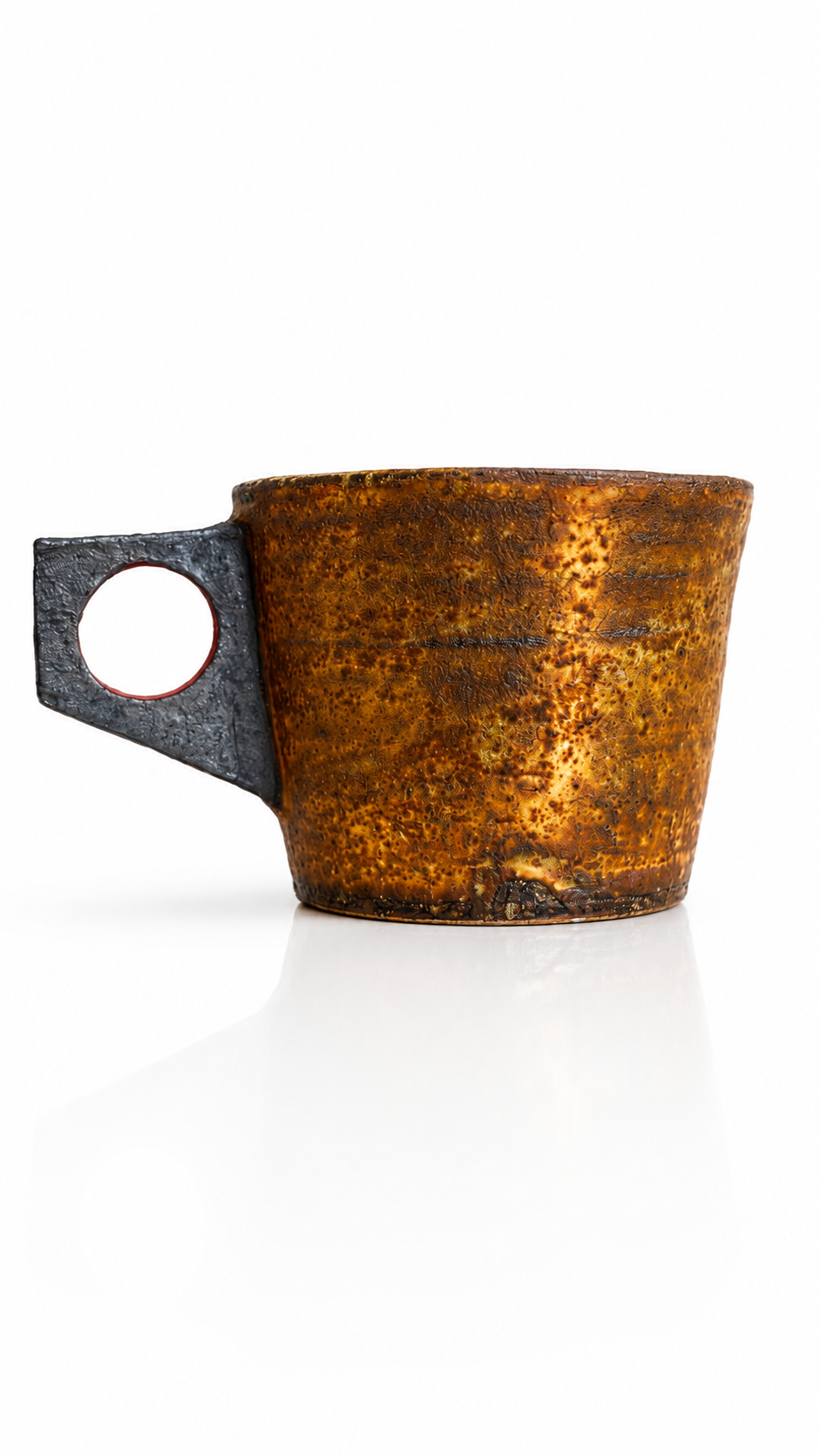 Artisan Japanese pottery mug featuring rich amber glaze and modern ring handle design.