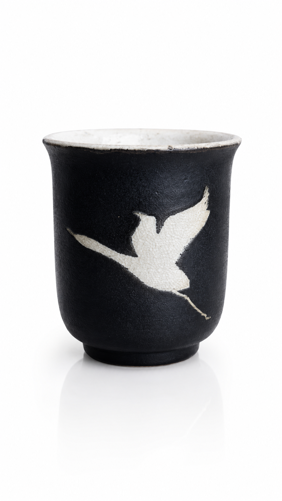 Handmade Midnight Crane Yunomi by Japanese ceramic artist Fukuda featuring a white flying crane motif on black glaze.