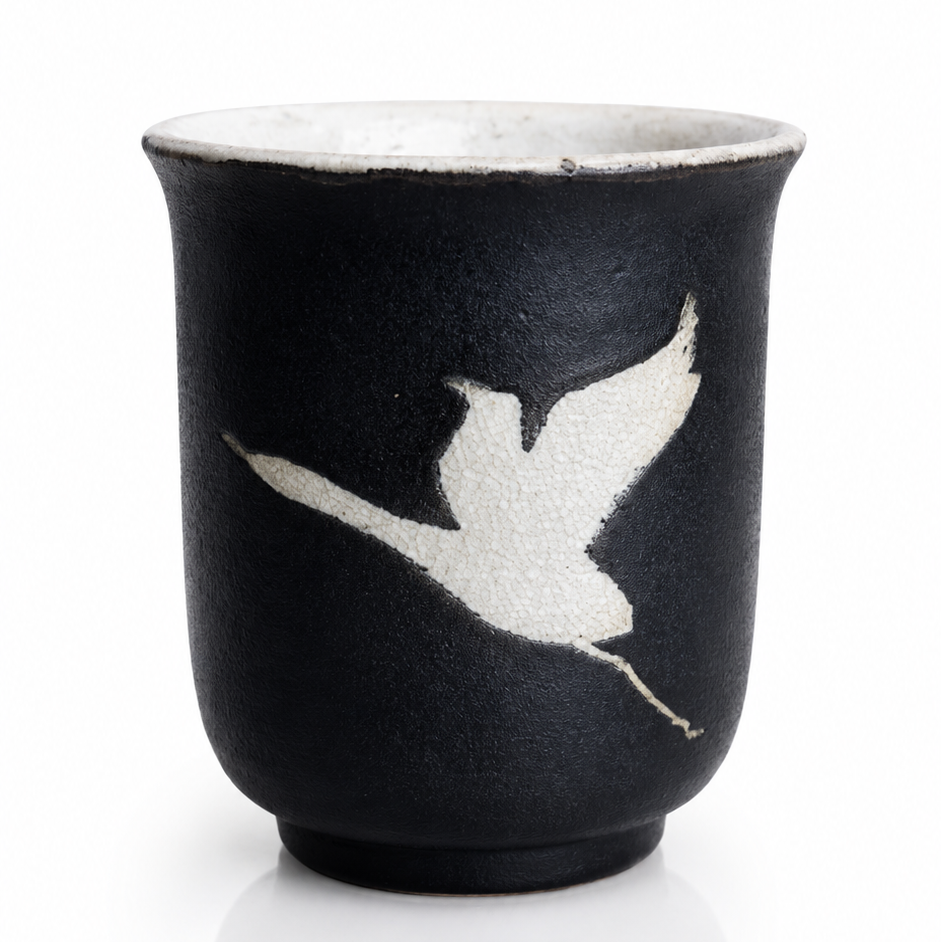 Handmade Midnight Crane Yunomi by Japanese ceramic artist Fukuda featuring a white flying crane motif on black glaze.