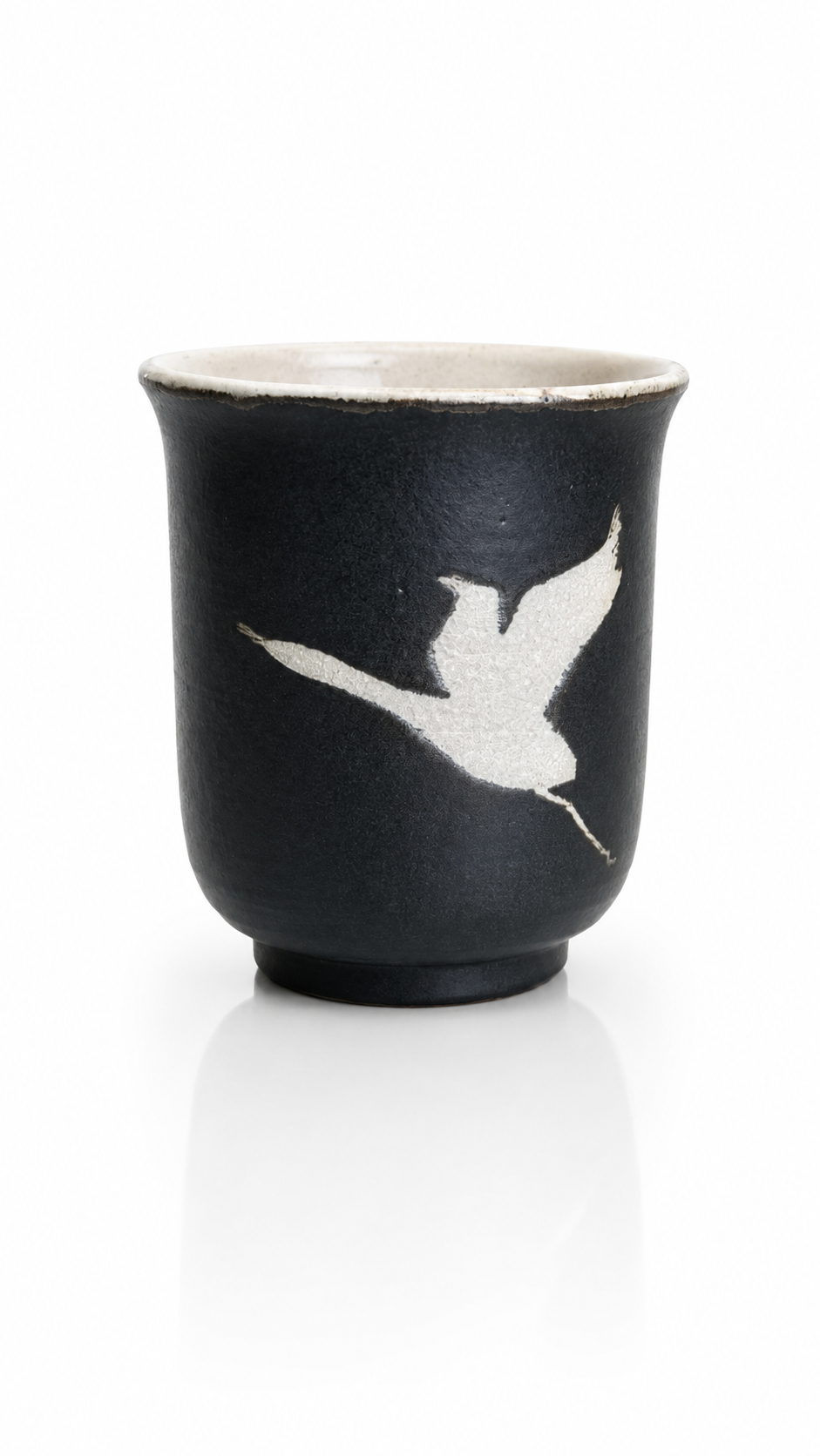 Black Japanese yunomi tea cup with traditional crane design handcrafted in Ibaraki, Japan.