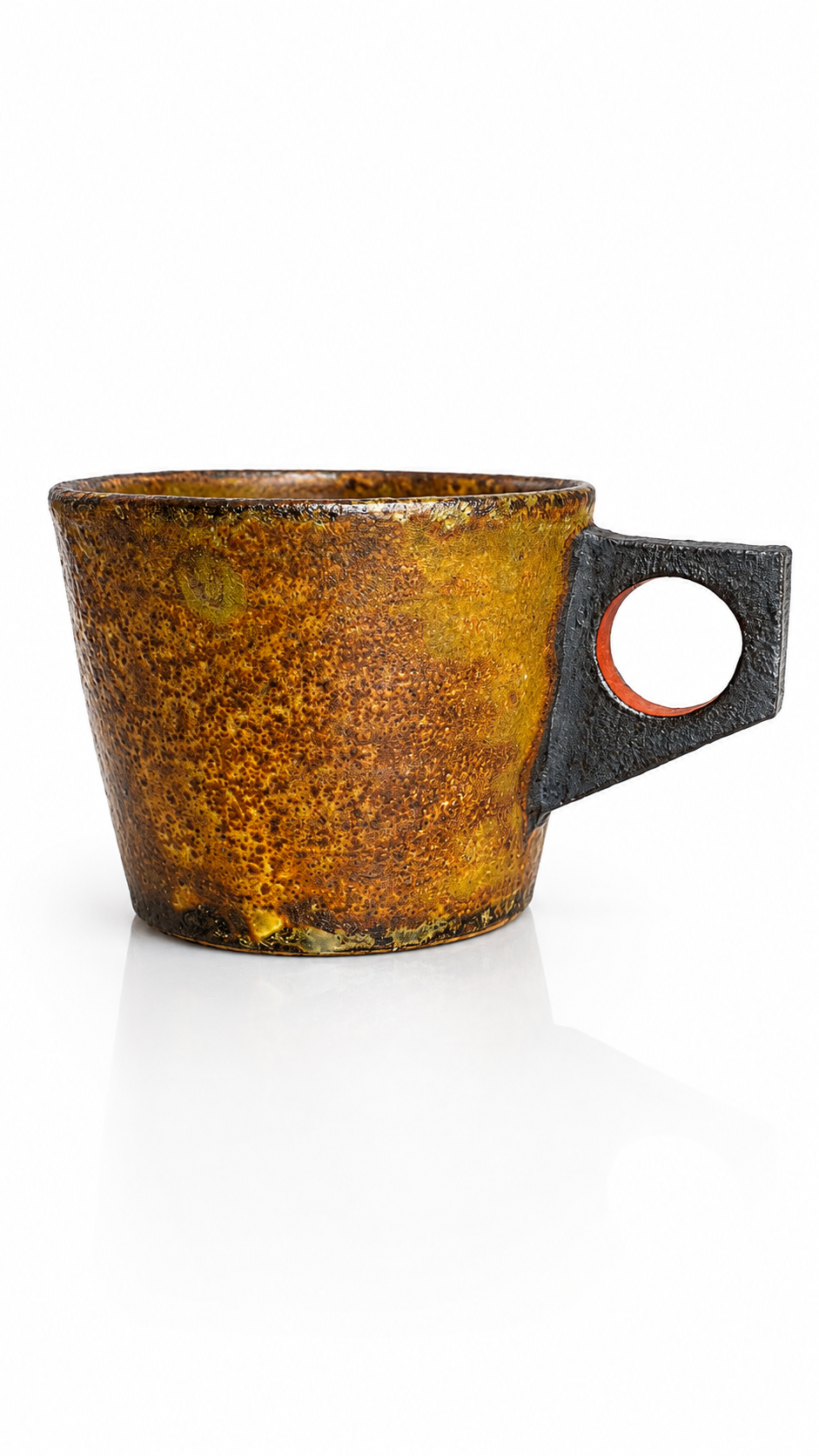 Handmade Japanese ceramic mug with ember-toned glaze and sculptural ring handle inspired by Mashiko pottery.